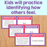 Educational cards on a wooden surface with text about identifying emotions.