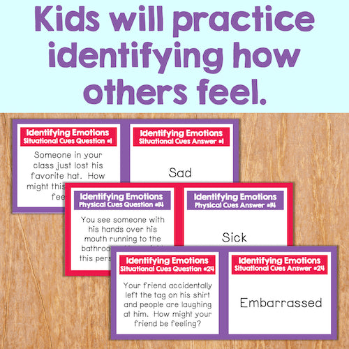 Educational cards on a wooden surface with text about identifying emotions.