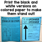 Two educational posters on a wooden surface with text about being an upstander or bystander.