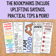 Set of bookmarks with uplifting sayings and practical tips on a wooden surface.