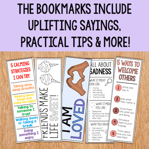 Set of bookmarks with uplifting sayings and practical tips on a wooden surface.