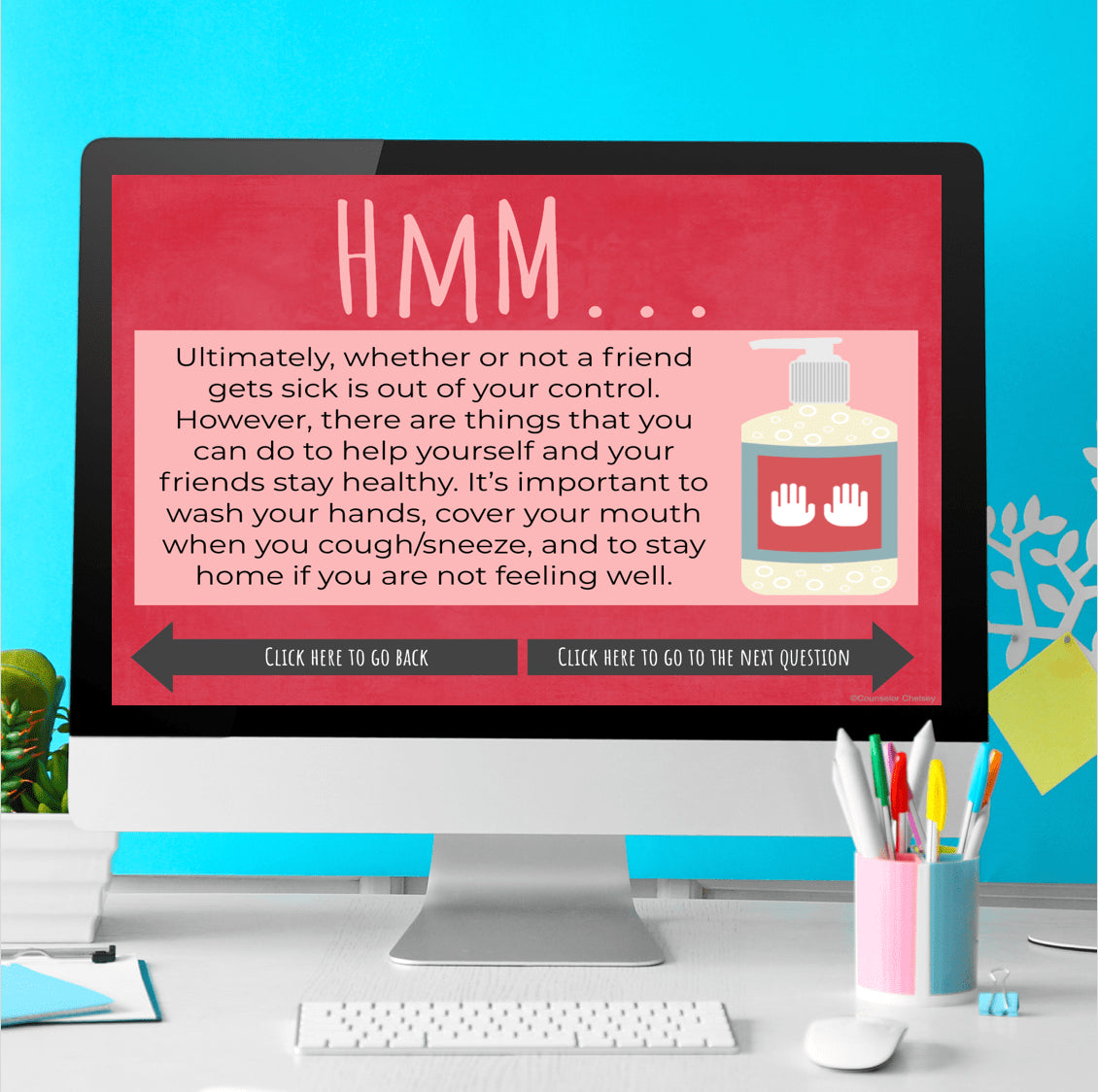 Computer screen displaying a health message with hand sanitizer image on a colorful desk.