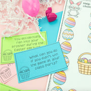 Educational cards with Easter-themed questions on a pink surface with Easter decorations.