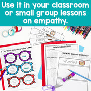 Educational materials for empathy lessons with worksheets and coloring supplies on a blue background.