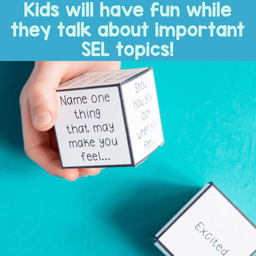 Hand holding a cube with text on it against a blue background