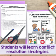 Conflict resolution worksheet and interactive tool on a wooden surface with glue stick and scissors.