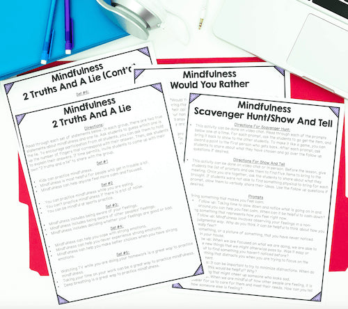 Mindfulness activity sheets on a white surface with a blue background