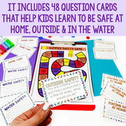 Colorful safety-themed game cards held by a hand with text about learning safety at home, outside, and in water.