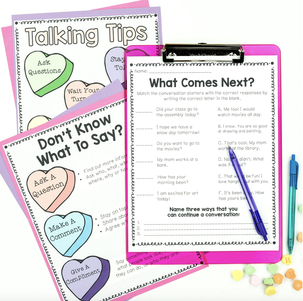 Educational materials on a clipboard with colorful heart-shaped cards and pens.