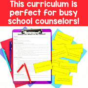 Curriculum materials for school counselors with a clipboard, papers, and colorful cards on a red background.
