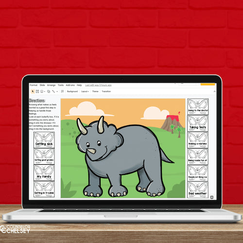 Laptop displaying a digital worksheet with a triceratops illustration on a red brick background